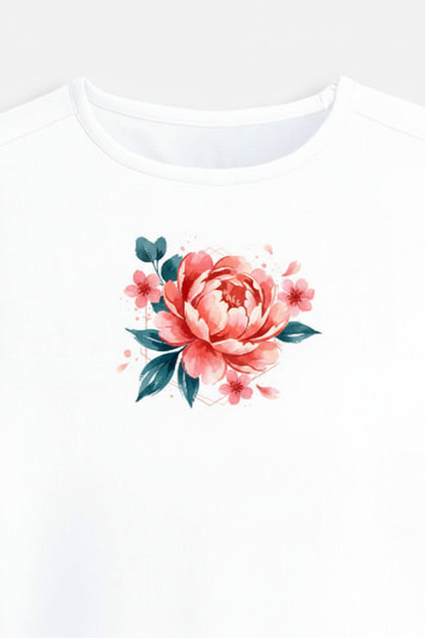 A white short-sleeve crop top t-shirt featuring a watercolor-style graphic of a pink peony flower with green leaves on the center chest, displayed against a light gray background.
