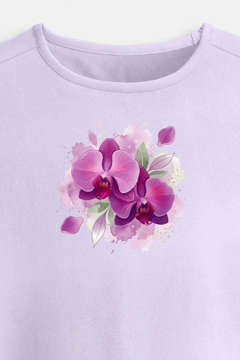 A light lavender short-sleeve crop top with a watercolor-style purple and pink orchid graphic on the chest, displayed against a light gray background.