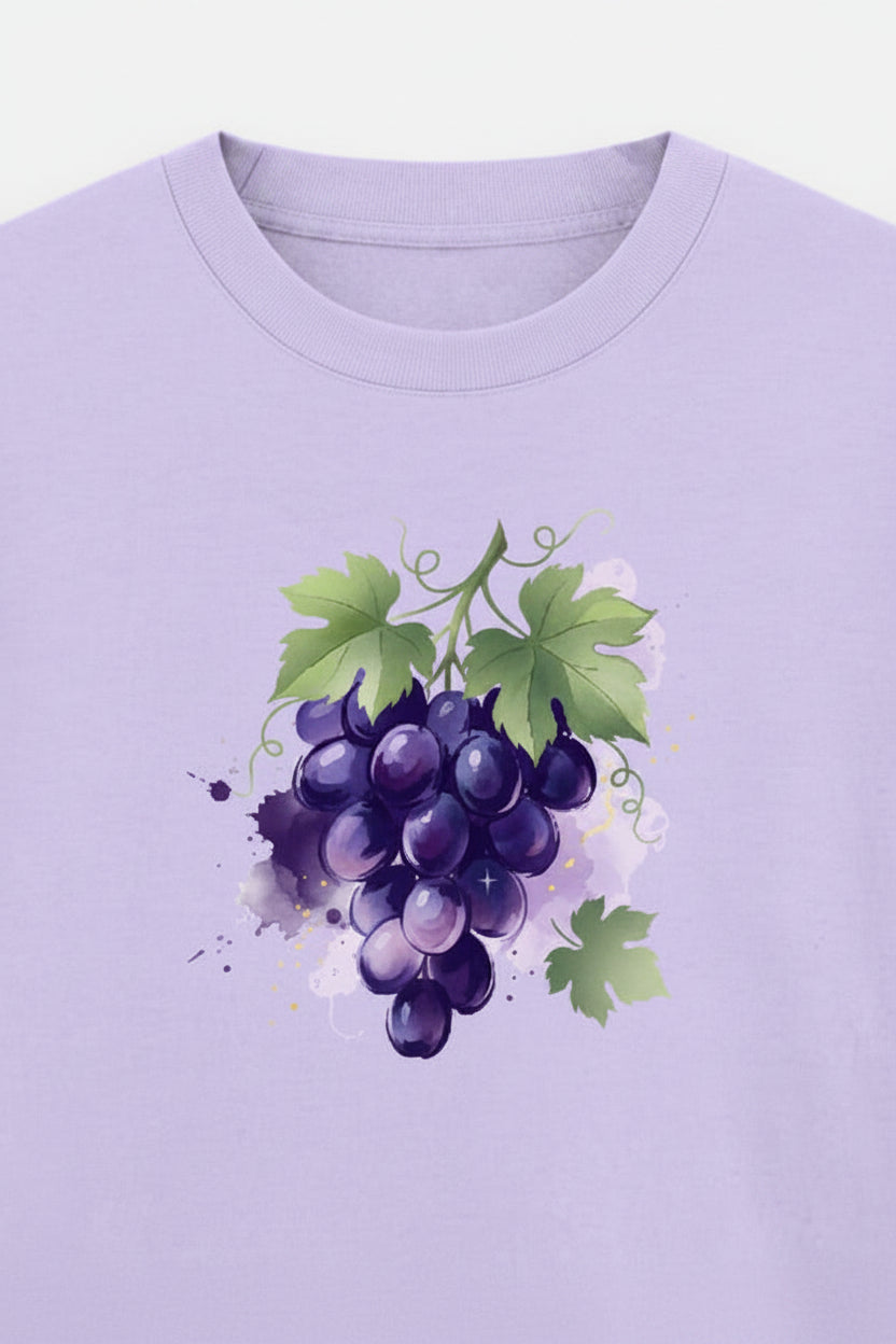 A light purple short-sleeve t-shirt with a watercolor-style graphic of purple grapes and green leaves on the chest, displayed against a light gray background.